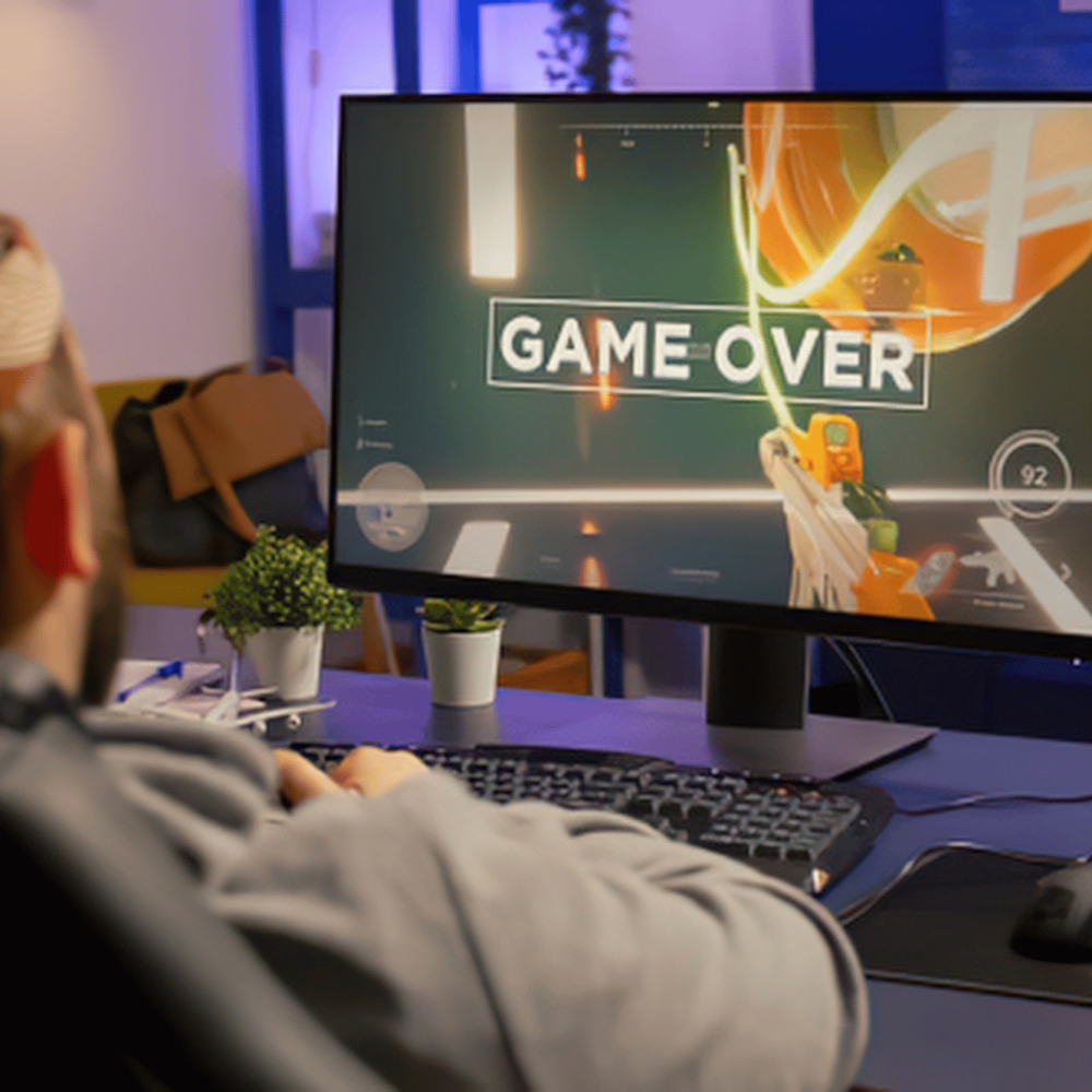 Man playing game showing game over screen